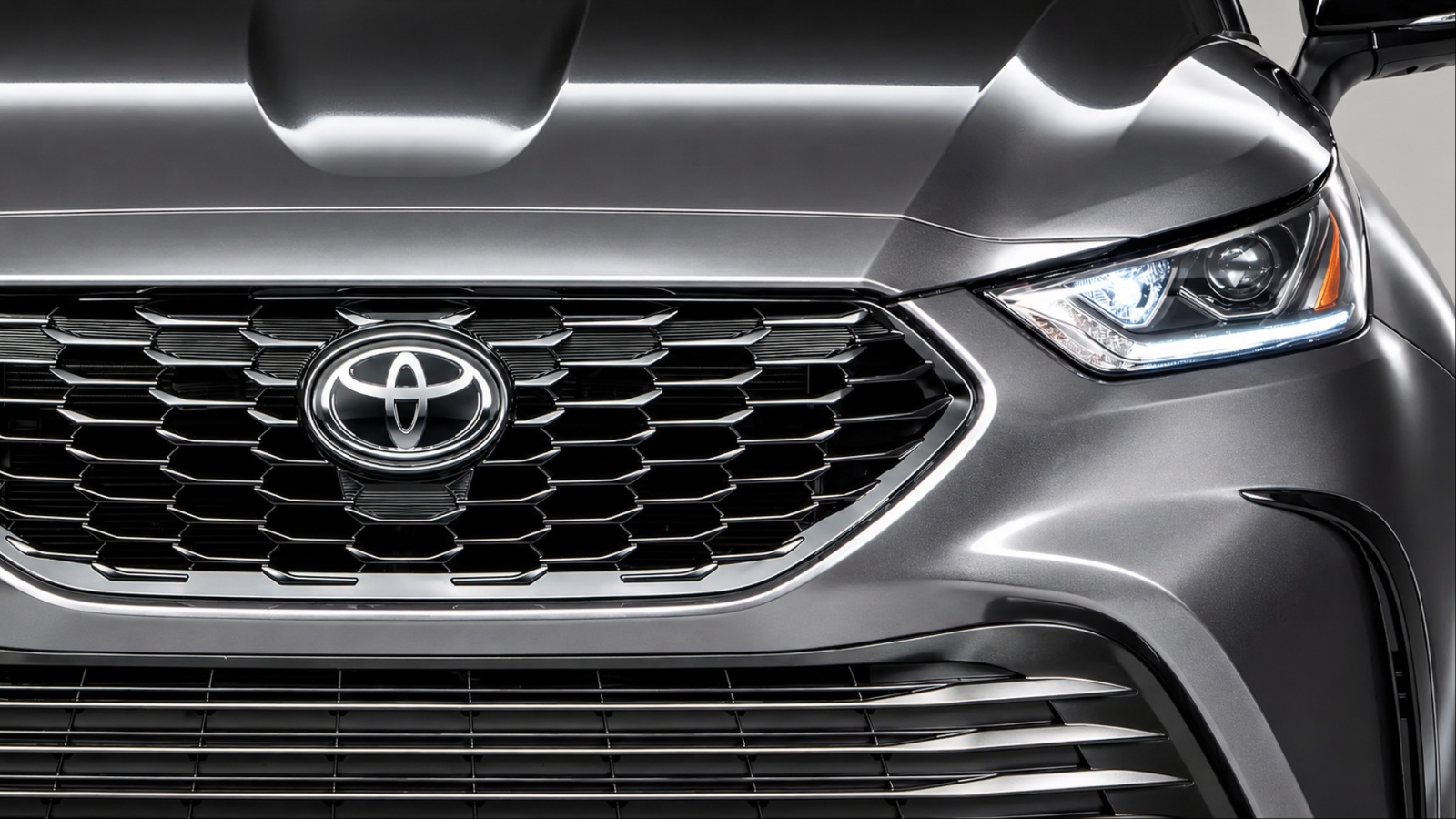 Close up of gray Toyota Highlander front grille and headlight