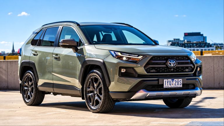Toyota RAV4 SUV parked on a rooftop overlooking a city skyline