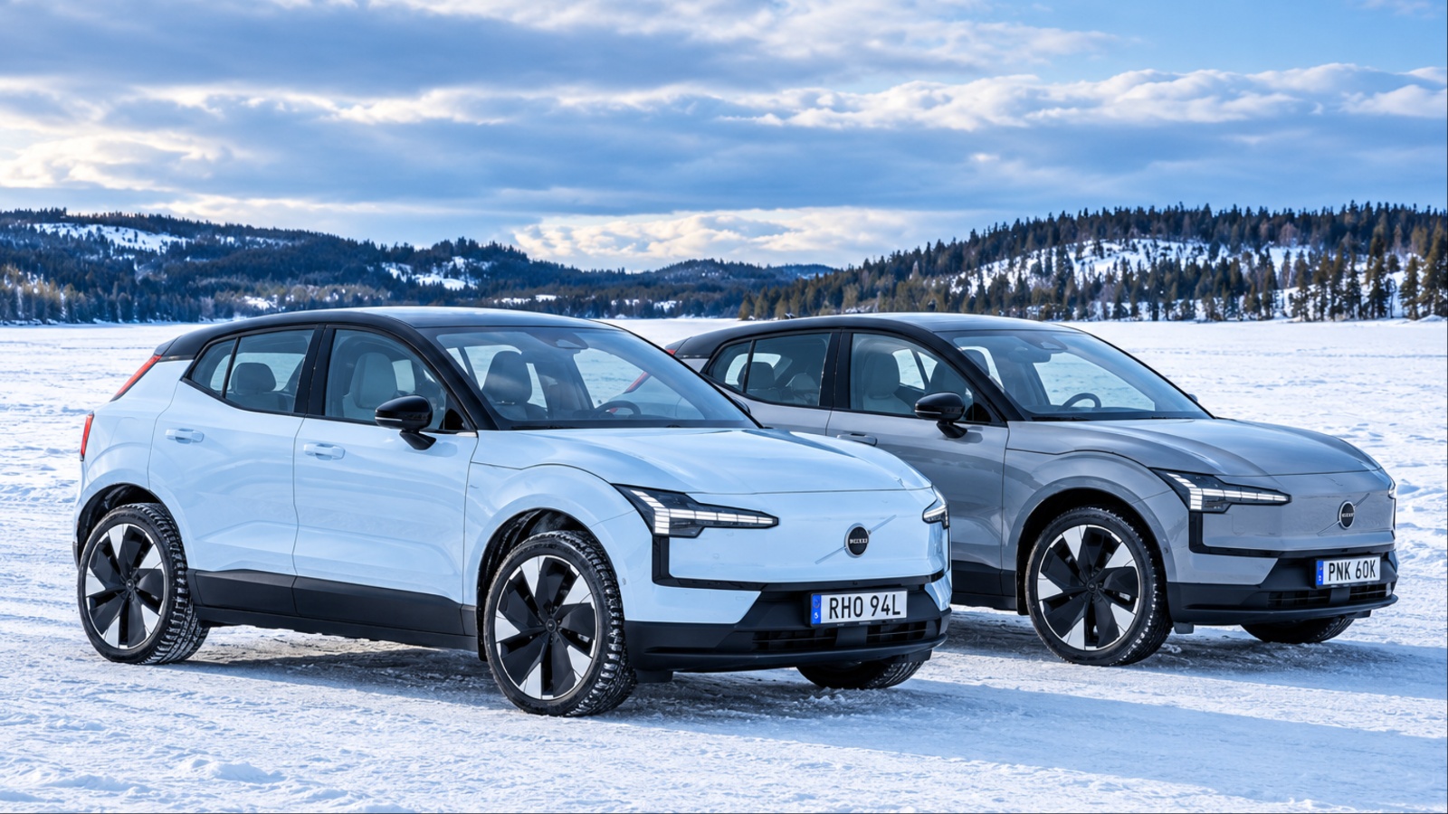 White and gray Volvo EX30 electric SUVs parked in snow