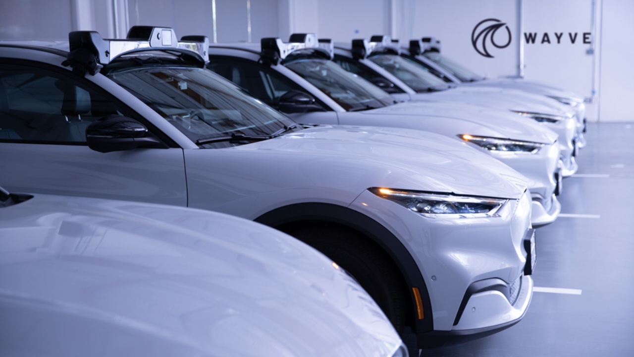 Wayve autonomous-driving vehicles equipped with roof-mounted sensor systems inside a facility