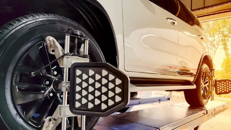 Wheel alignment equipment mounted on a vehicle during a professional alignment service