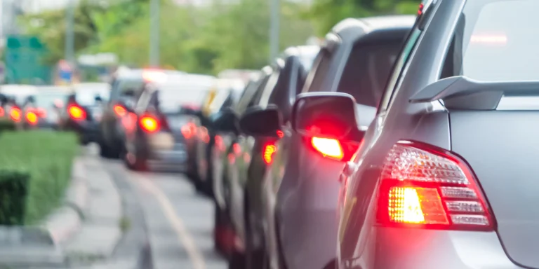 Many cars are stuck in a busy lane and are moving slowly