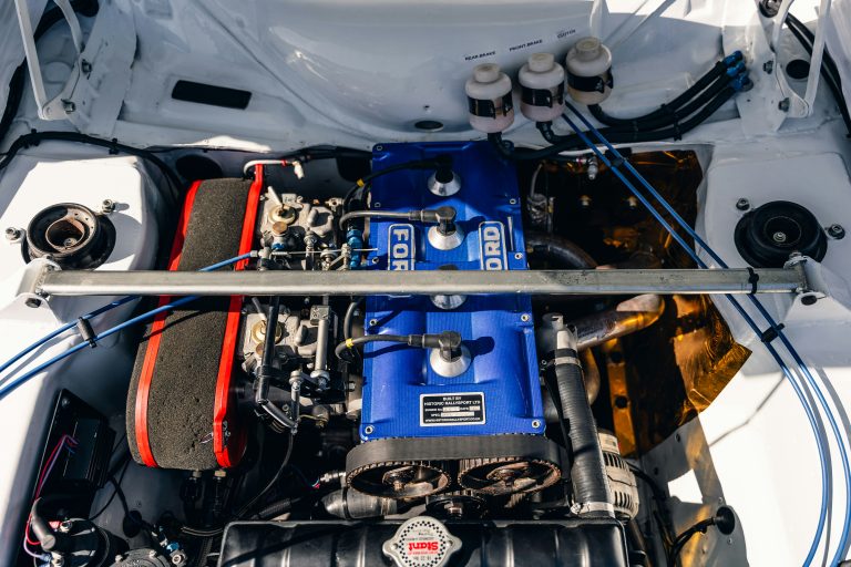 An engine is shown after opening the hood