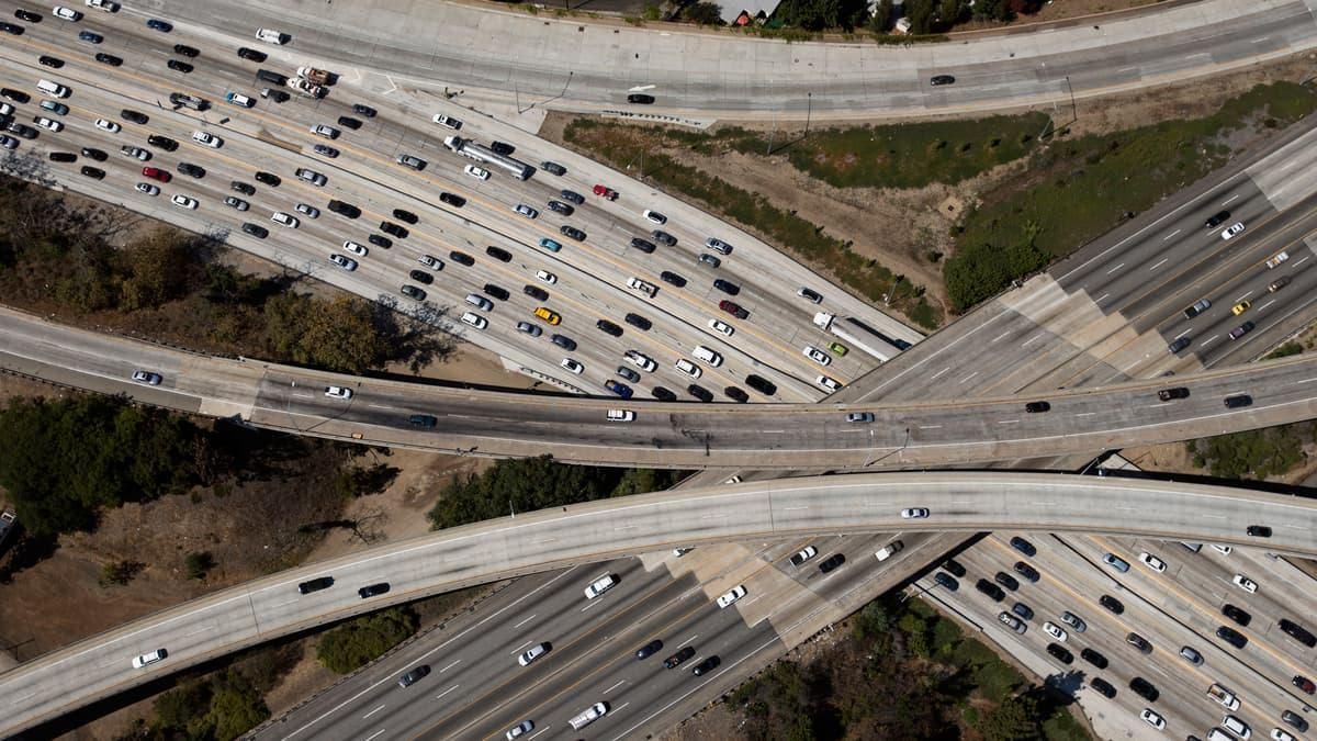 Aerial view of a busy multi-level highway interchange with many vehicles