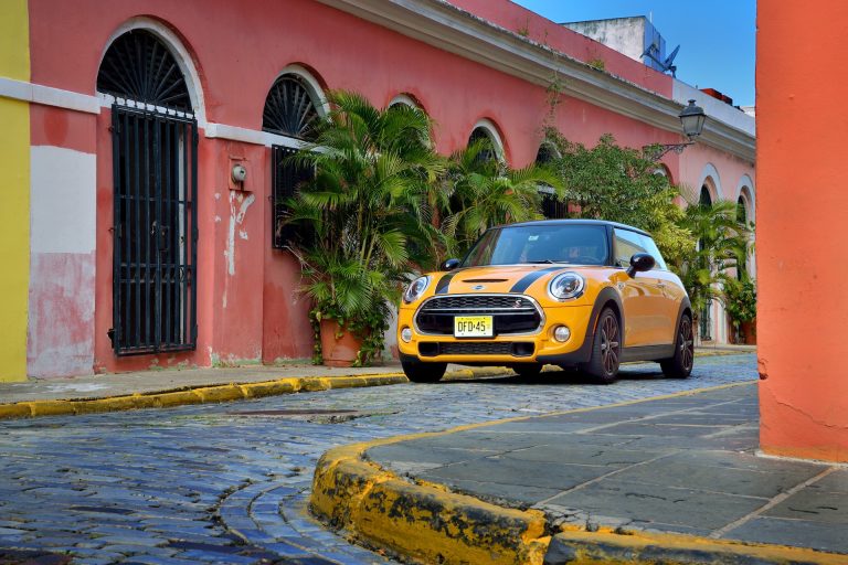 A Mini is stanidng in the colorful streets of a town