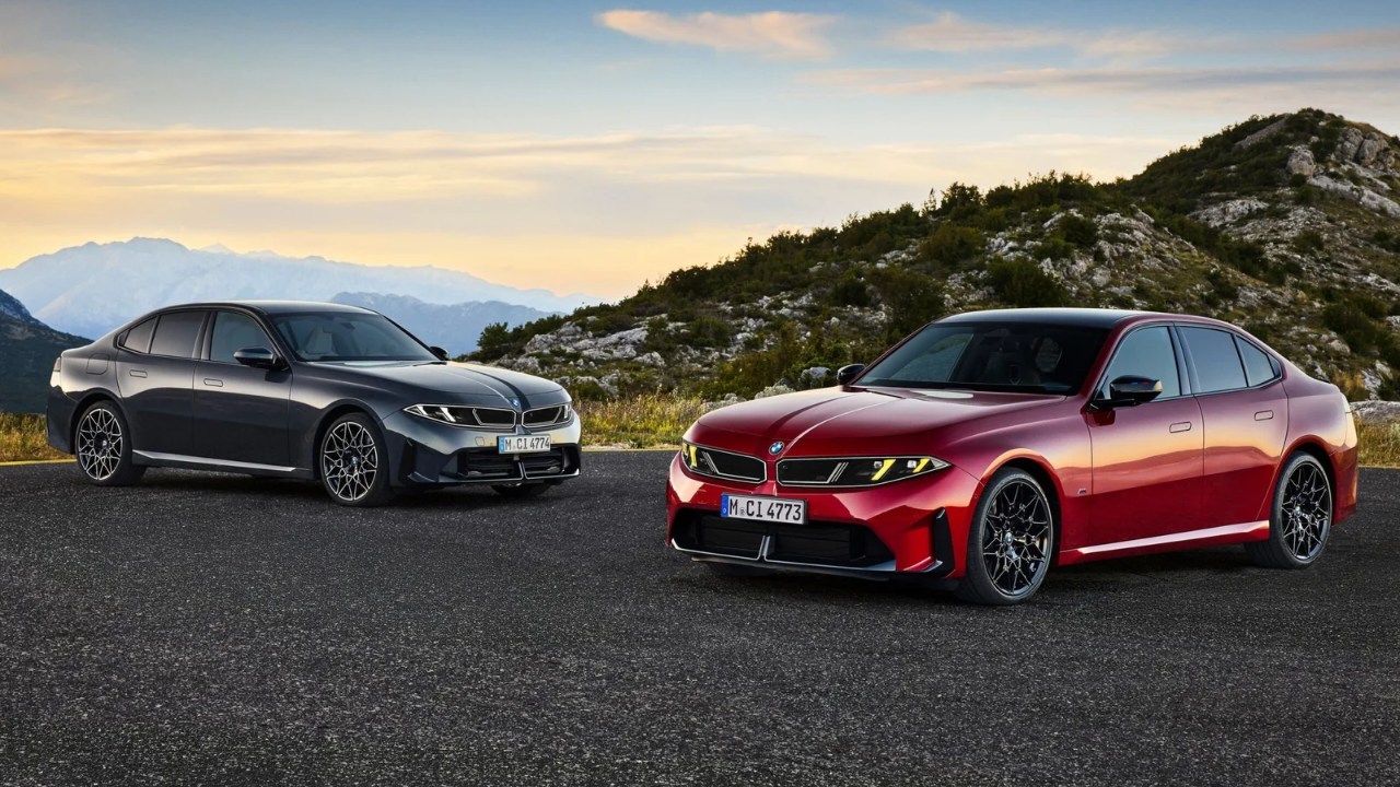 2027 BMW M350 xDrive sedan parked on a mountain road with rugged peaks in the background