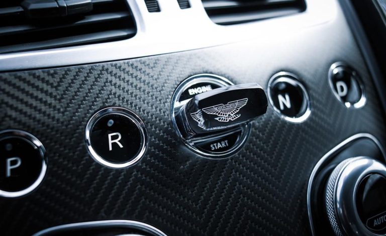 A stylish car key is shown in the knob