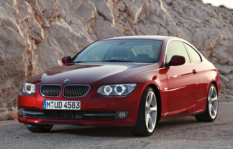 A BMW 3 Series is standing on a hilly road