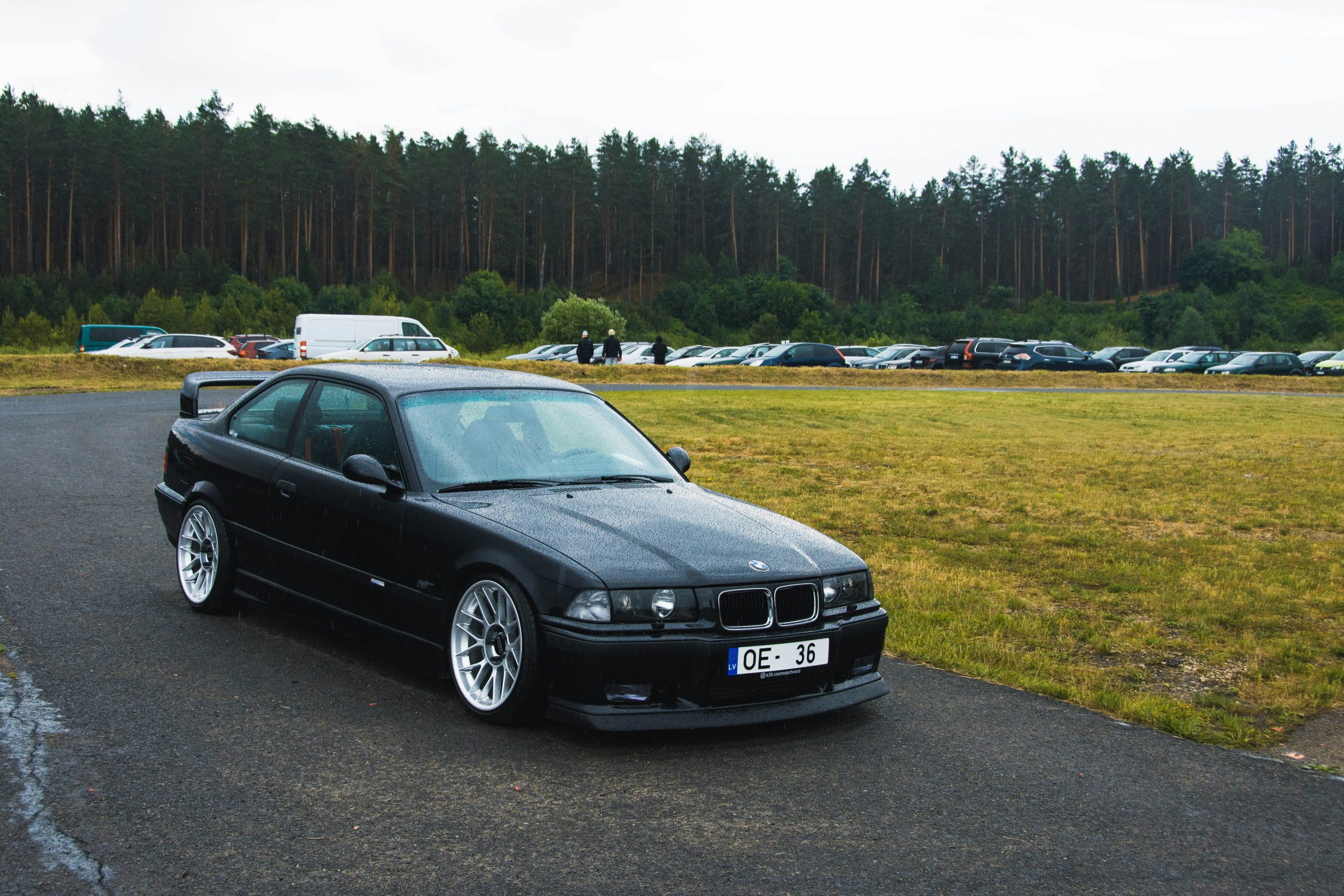 A Black BMW is riding on a cloudy day