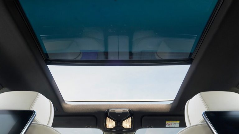 BMW 6 Series Gran Turismo interior featuring a panoramic glass roof, ambient lighting, and premium white leather seats