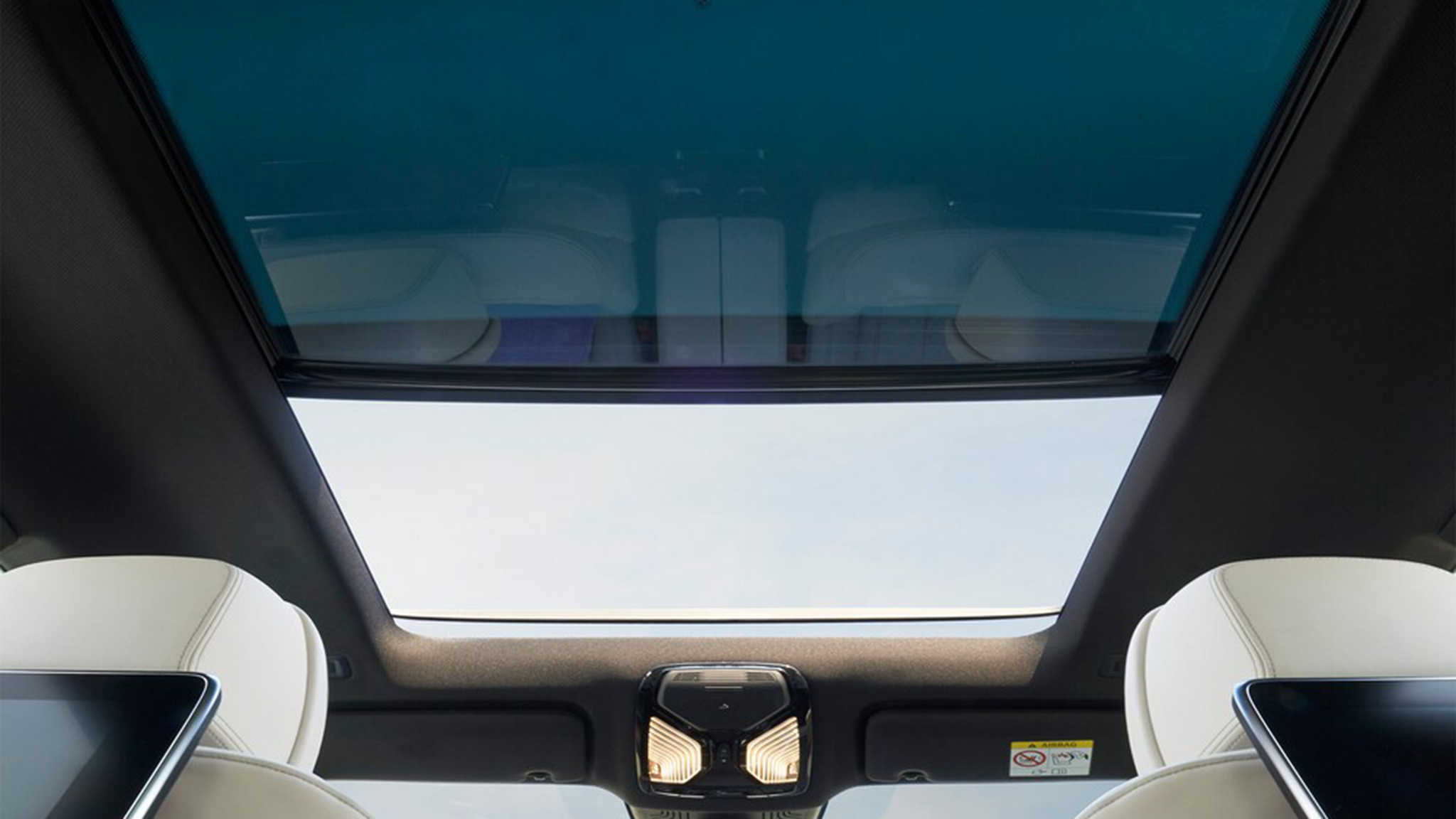 BMW 6 Series Gran Turismo interior featuring a panoramic glass roof, ambient lighting, and premium white leather seats
