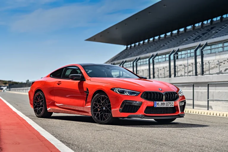 A BMW M8 is standning on a race track on a sunny day