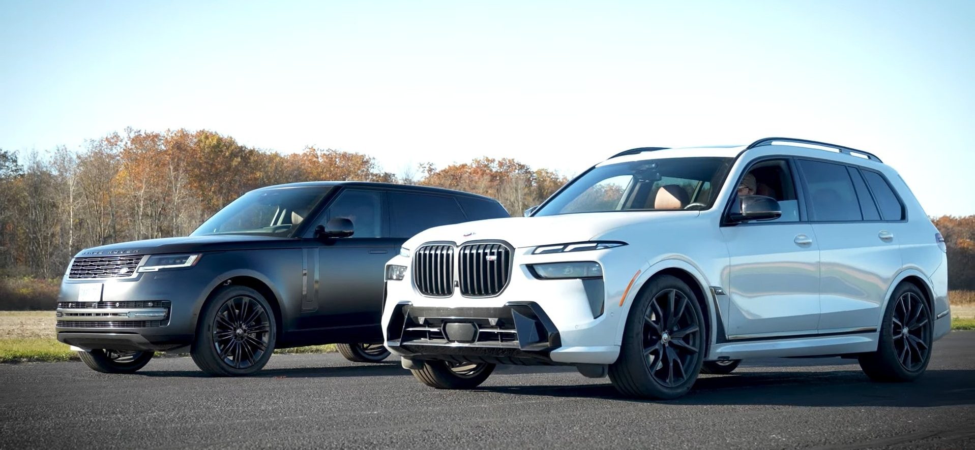 BMW X7 M60i in white parked alongside a Range Rover P530