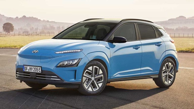 Blue Hyundai Kona Electric parked on a quiet country road with fields and hills behind