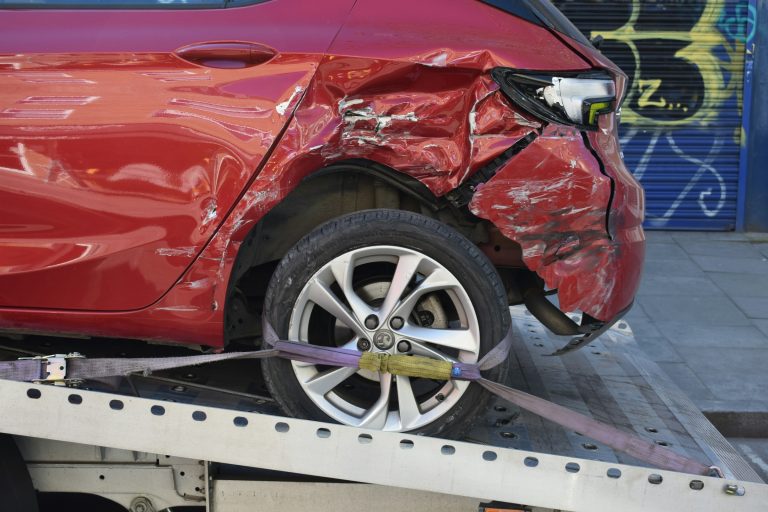A car is geeting towed after an accident