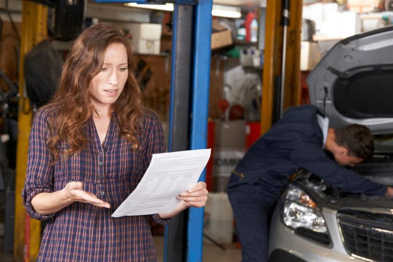 Woman reviewing a car repair bill.