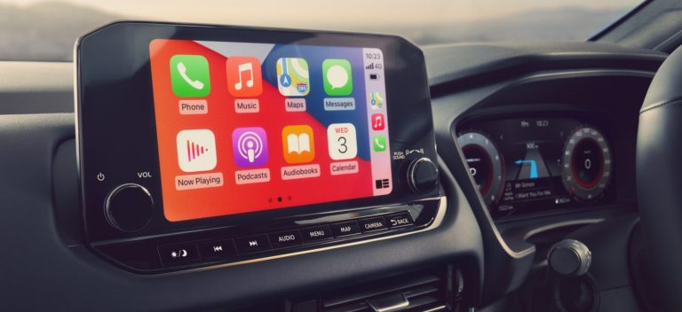 Car infotainment touchscreen displaying Apple CarPlay apps for navigation, music, calls, and messaging