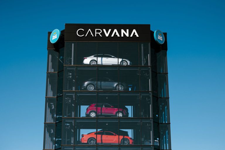 Carvana’s glass vehicle tower displaying multiple cars inside its distinctive automated dealership