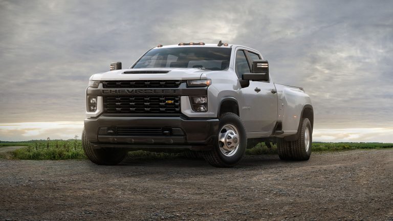Chevrolet Silverado 3500HD heavy-duty pickup parked on open terrain beneath a dramatic cloudy sky