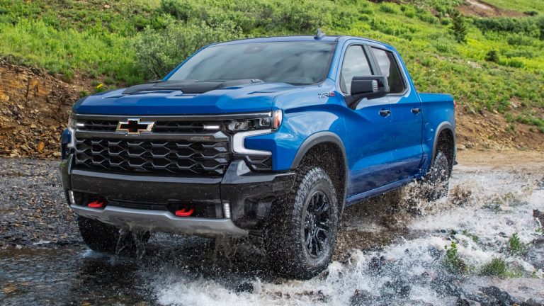 Chevrolet Silverado ZR2 splashes through a rocky stream, demonstrating its rugged off-road capability