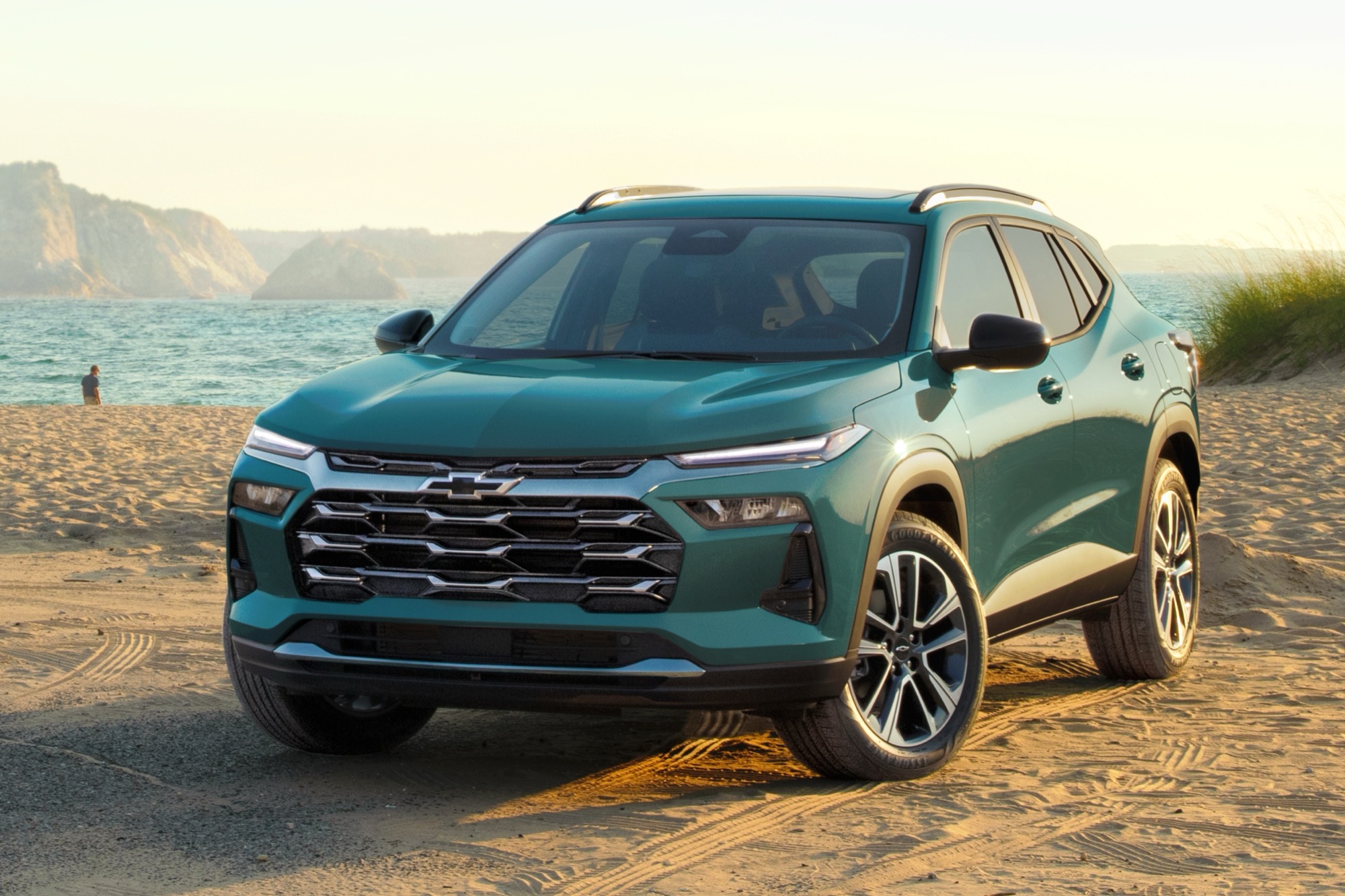 Chevrolet Trax parked on a sandy beach, with ocean views and warm sunset lighting