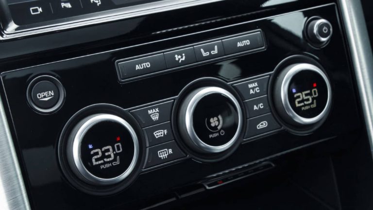 Close-up of a vehicle’s climate control panel featuring dual-zone temperature settings and ventilation controls