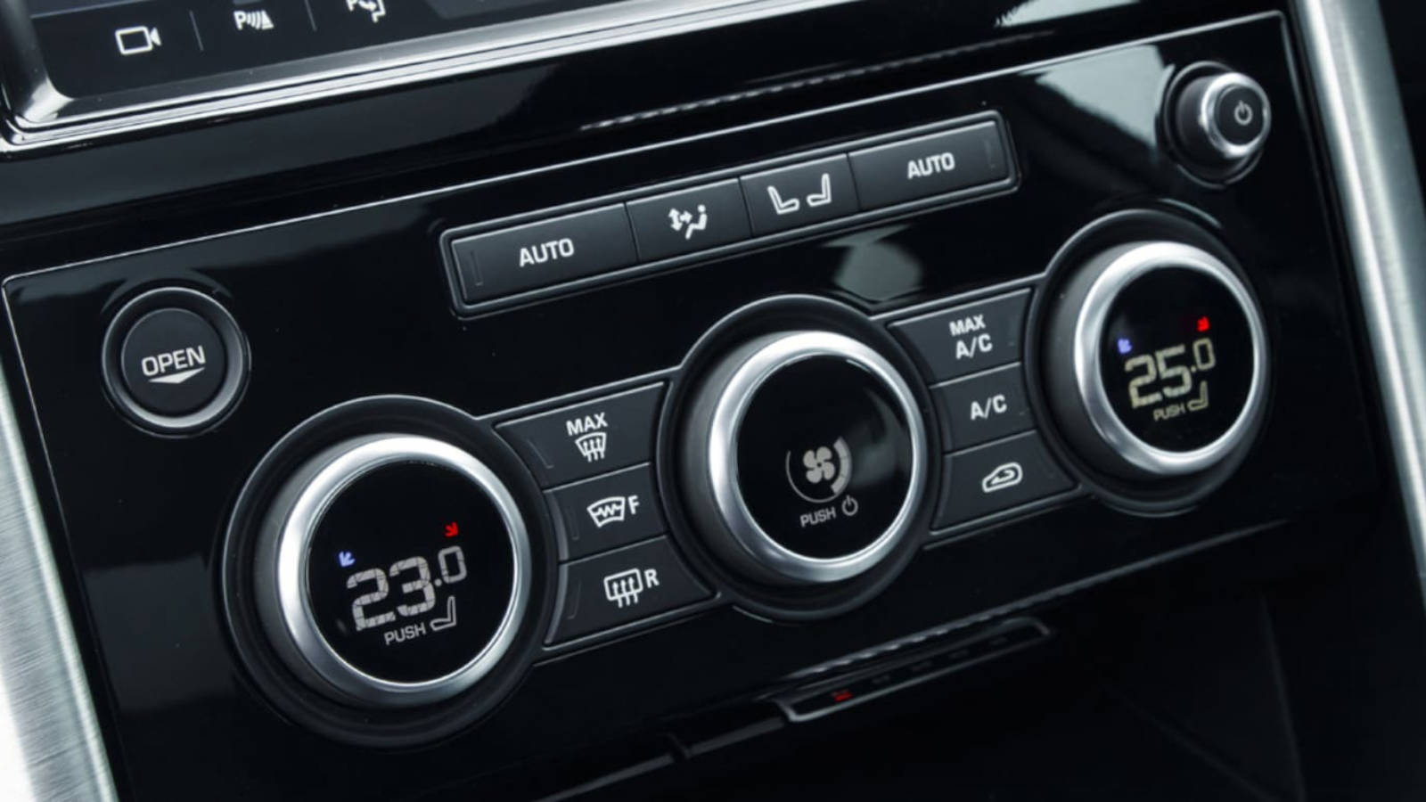 Close-up of a vehicle’s climate control panel featuring dual-zone temperature settings and ventilation controls