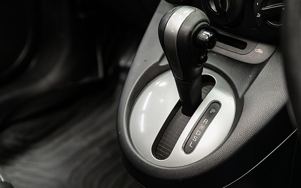 Close-up of an automatic transmission gear selector showing Park, Reverse, Neutral, Drive, and Low settings