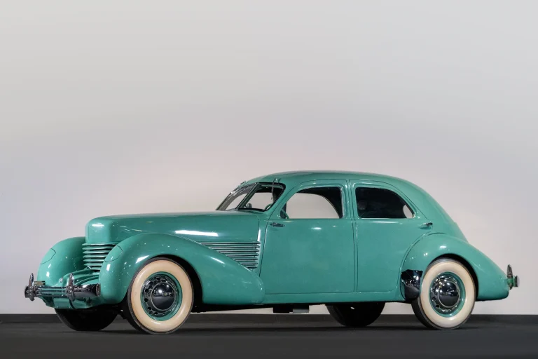 A vintage car is standing in a studio for photoshoot