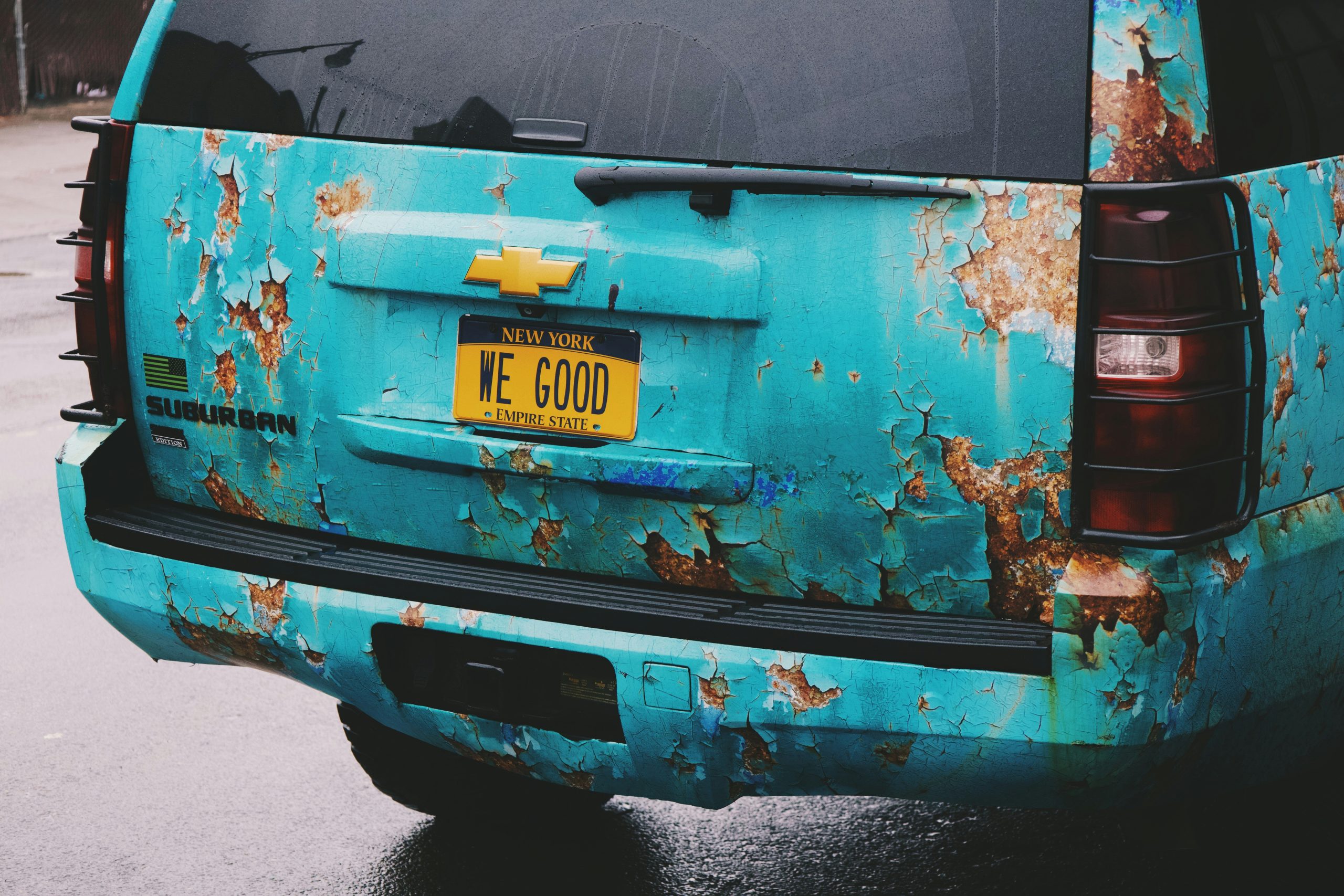 A ratted tatted bumper is shown of a car