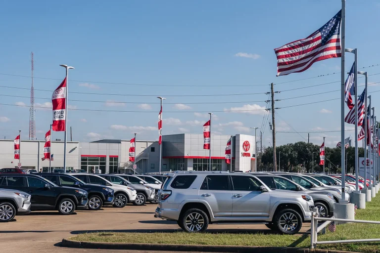 A local dealership is shown with manu cars standing in a series
