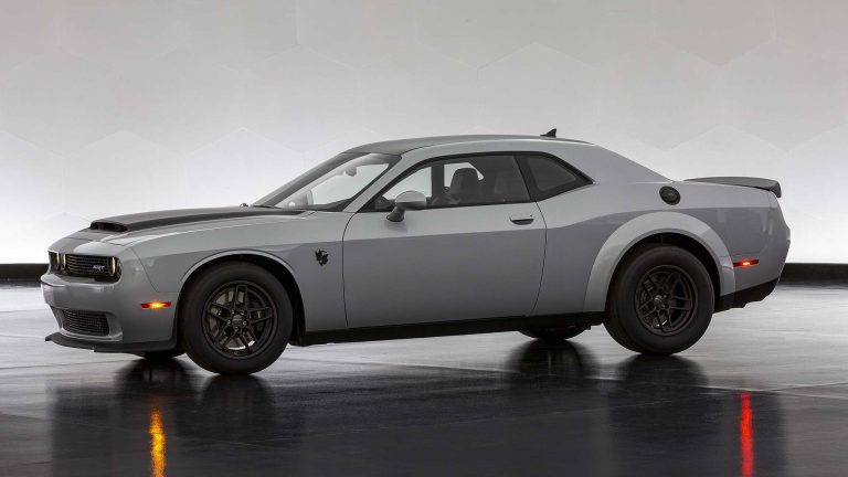 Dodge Challenger SRT parked indoors, showcasing its muscular design and wide stance