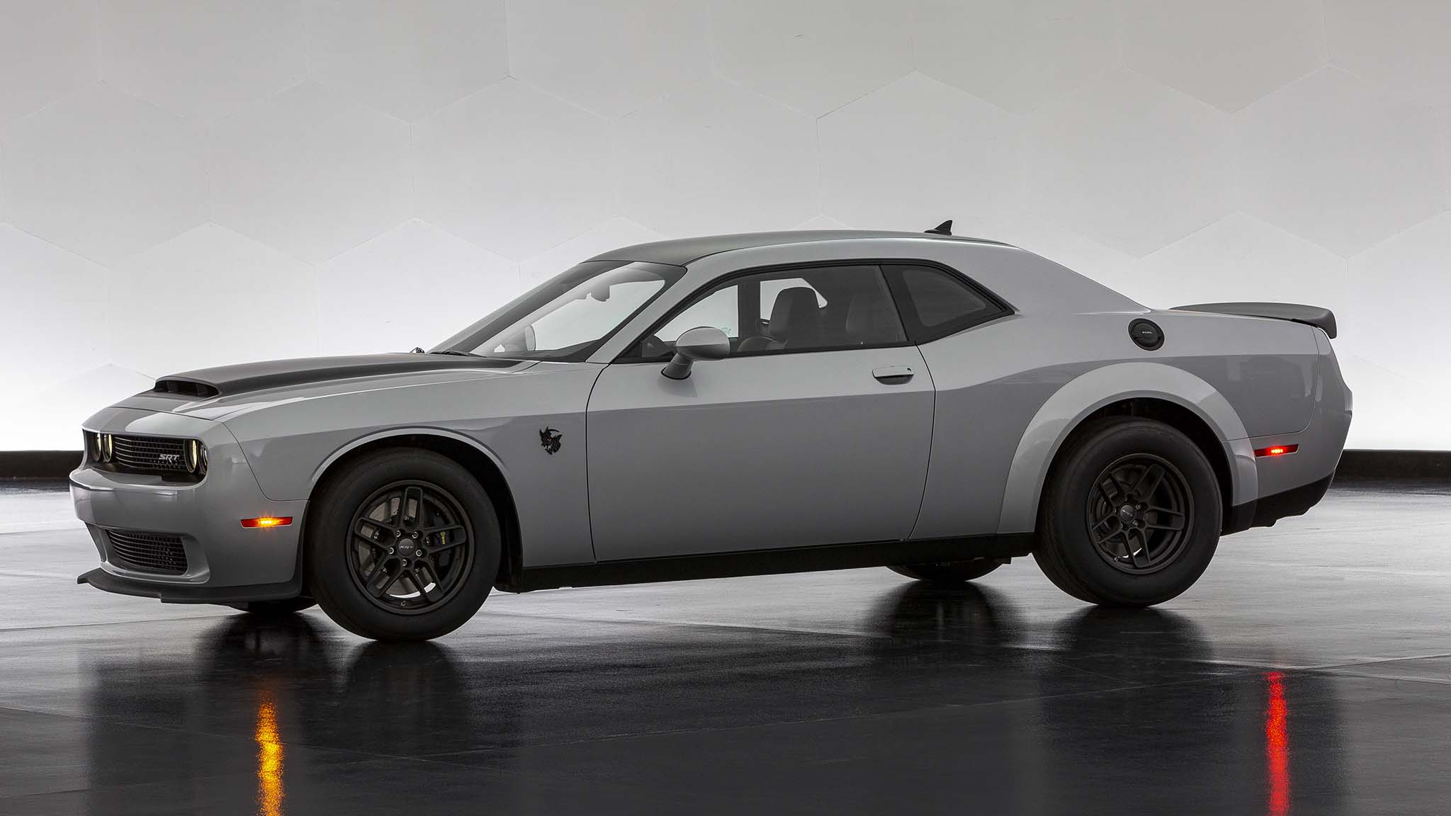 Dodge Challenger SRT parked indoors, showcasing its muscular design and wide stance