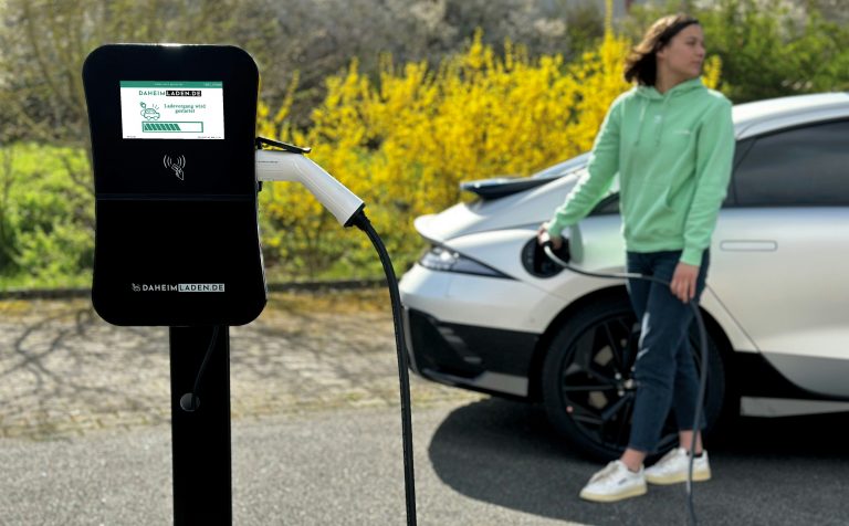 An EV CHrger is plugged in the car for charging in an open parking