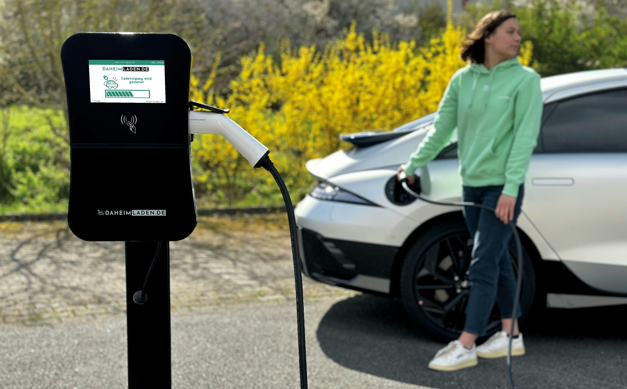 An EV CHrger is plugged in the car for charging in an open parking