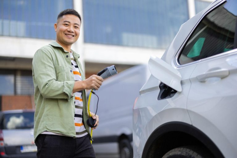 Happy EV owner charging vehicle