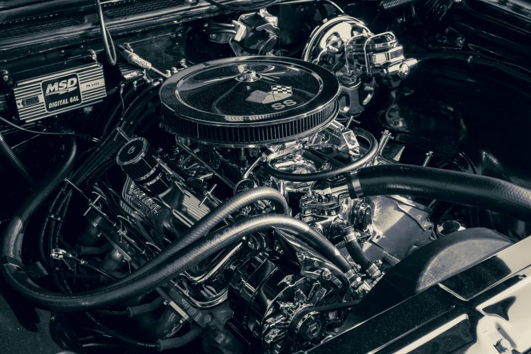 An engine isnide a hood is shown