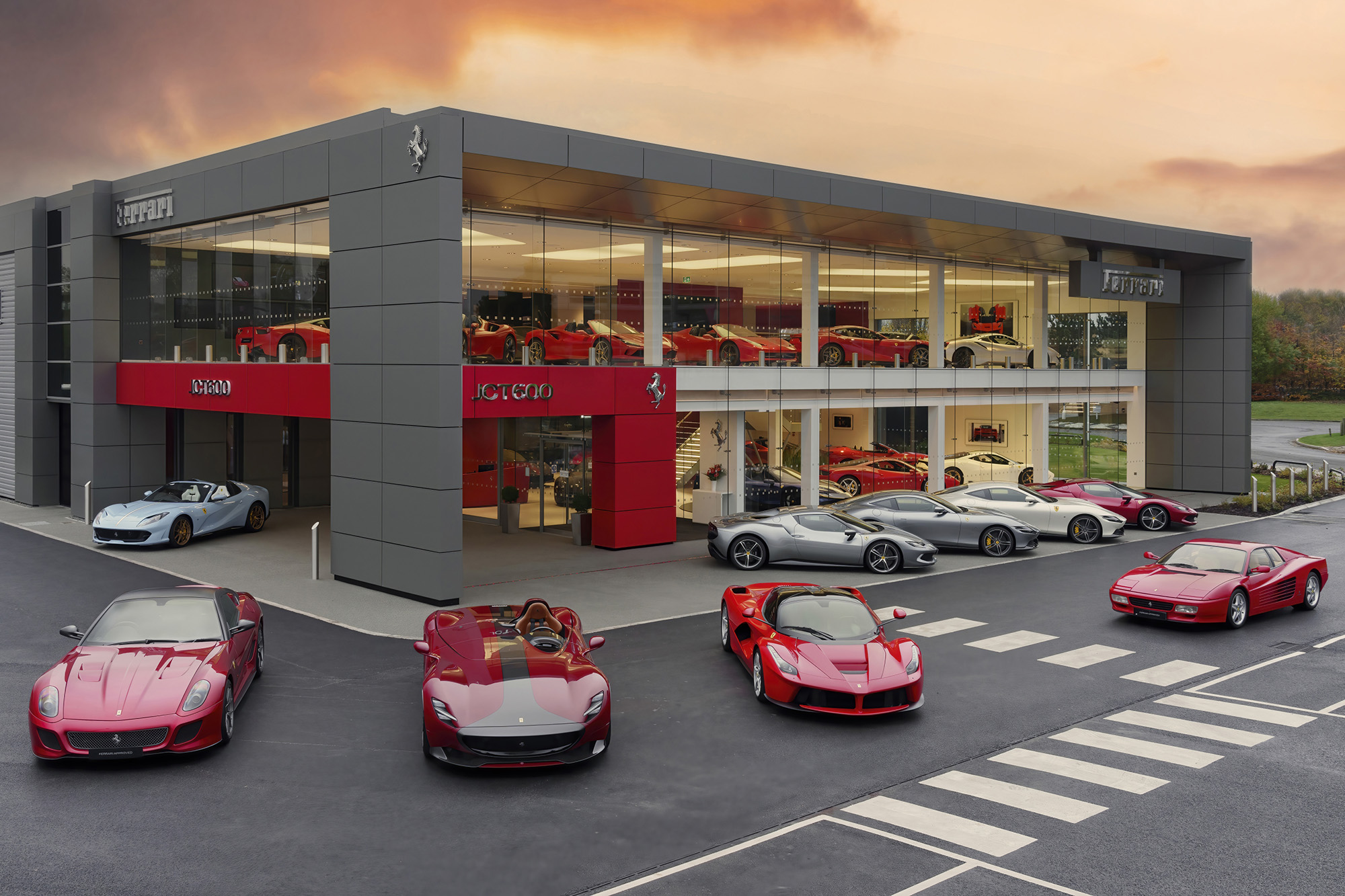 Ferrari dealership showcasing luxury sports cars inside and outside its modern showroom at sunset