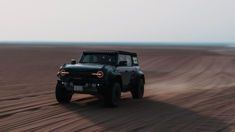 A Bronco is off orading on a desert