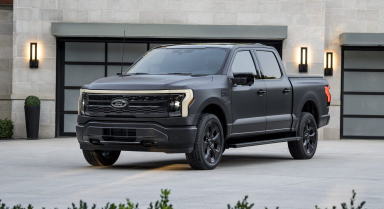 Ford F-150 Lightning parked outside a modern building, showcasing its rugged electric pickup design