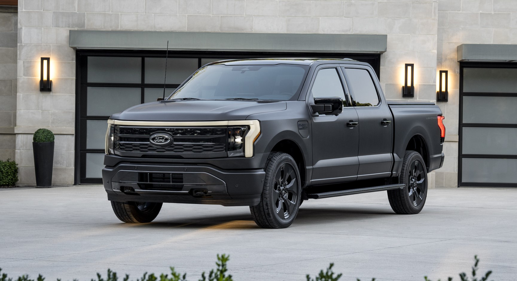 Ford F-150 Lightning parked outside a modern building, showcasing its rugged electric pickup design