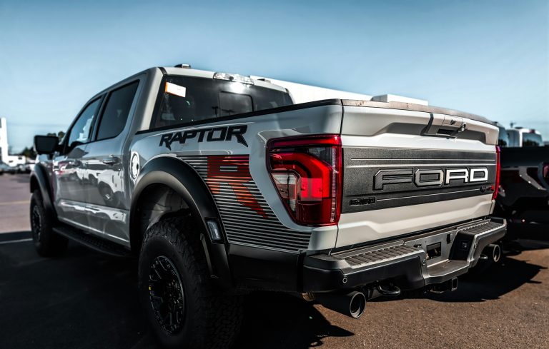 A F-150 Raptor is standind in an open parking