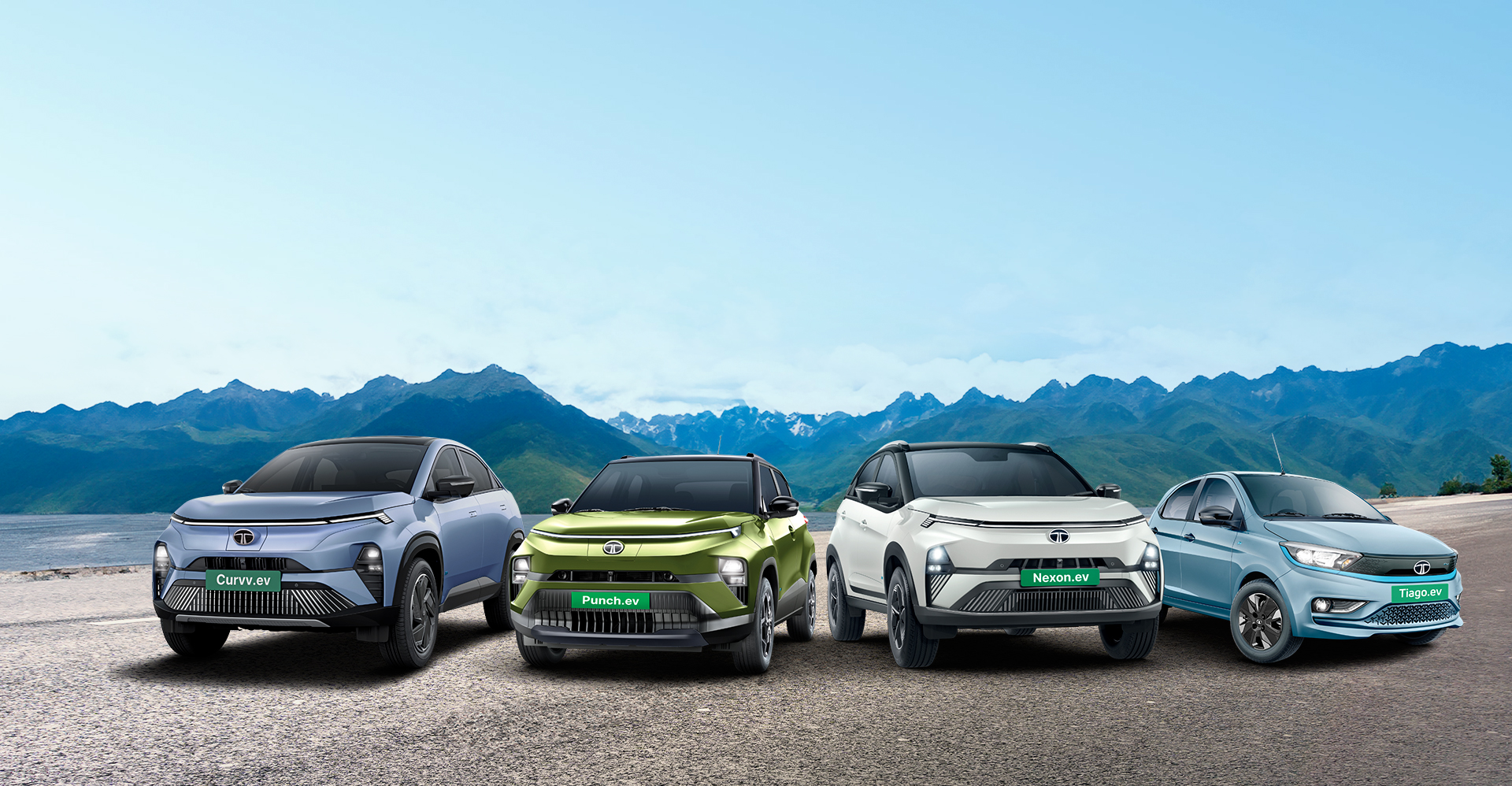 Four Tata electric vehicles, Curvv.ev, Punch.ev, Nexon.ev, and Tiago.ev, displayed against mountain scenery