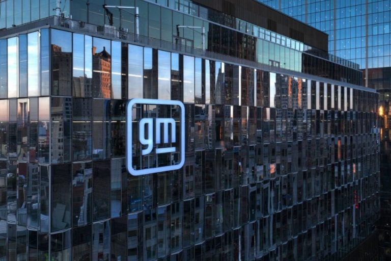 General Motors headquarters in Detroit featuring the illuminated GM logo on its glass exterior façade