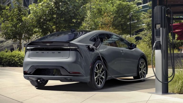 Gray Toyota Prius Prime XSE plugged into a public charging station