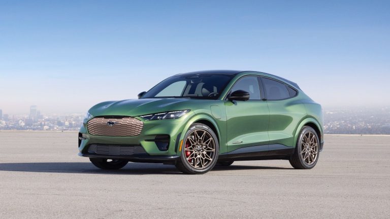 Green Ford Mustang Mach-E GT parked against a city skyline, highlighting its sporty all-electric crossover design