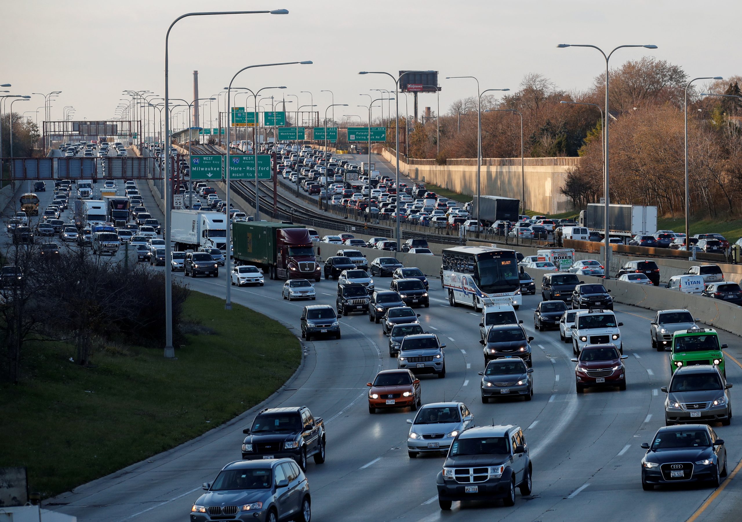 Heavy rush-hour traffic fills a multilane Chicago highway with cars, trucks, and buses