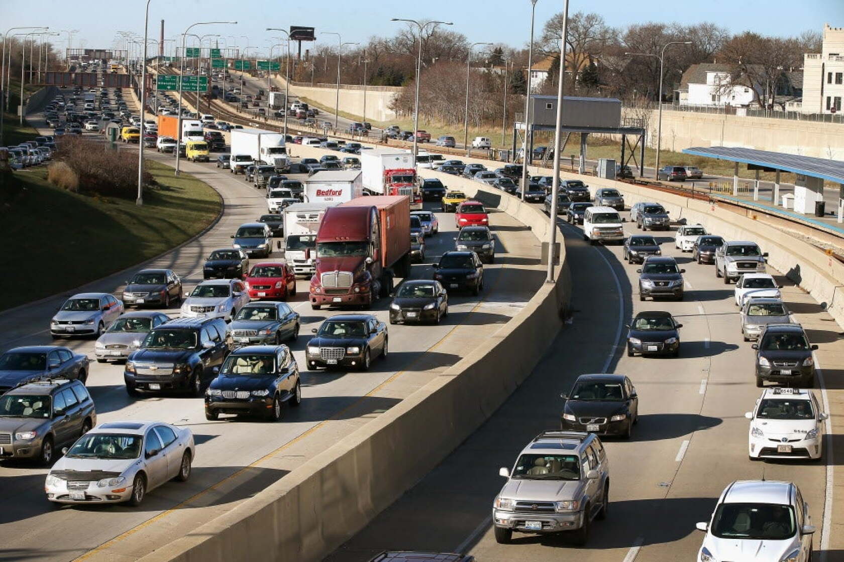 Heavy traffic fills a Chicago freeway as cars and trucks crowd multiple lanes