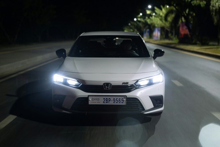 A white accord is riding at night