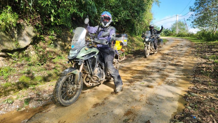 A rider on his bike is riding on a road filled with pot holes